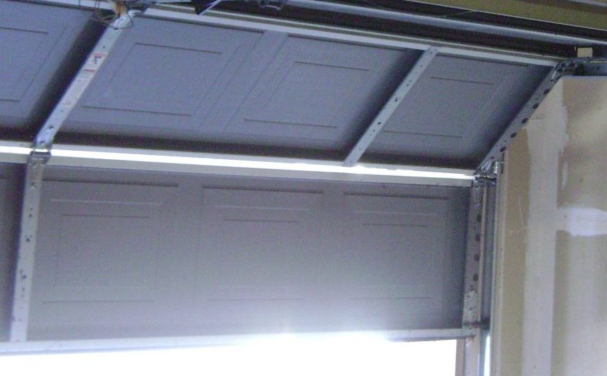 Sectional garage door panels and track hardware