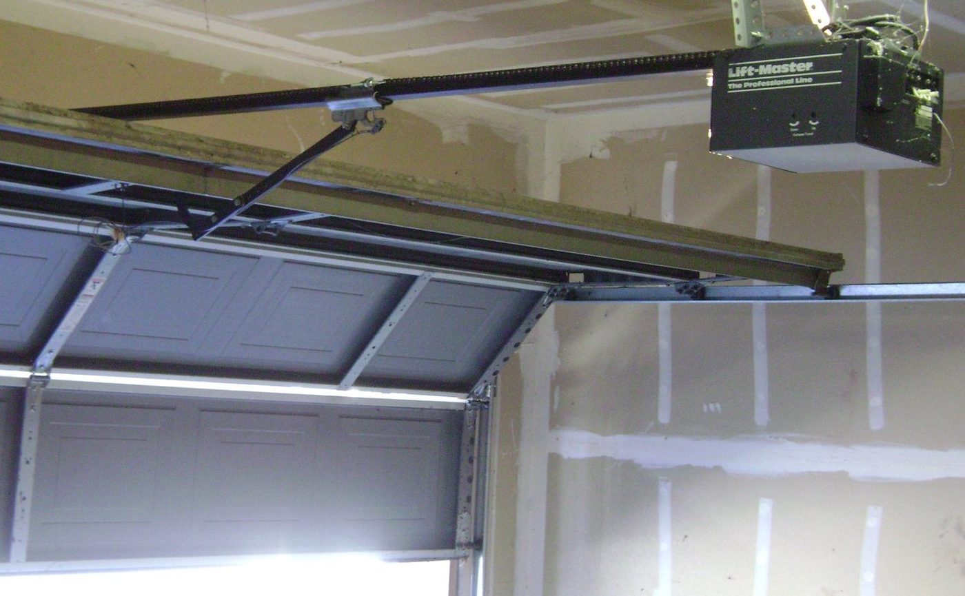 Chain drive garage door opener over a residential door
