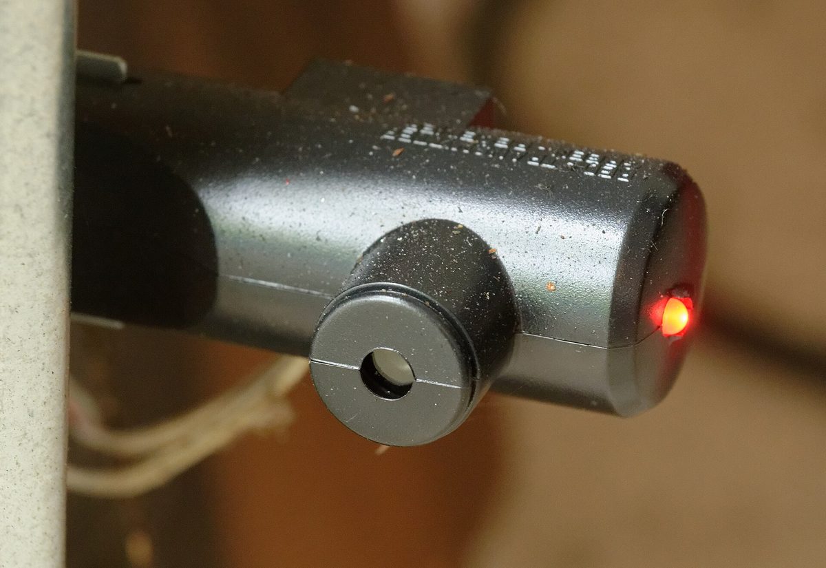 Garage door opener photo eye with the red light on
