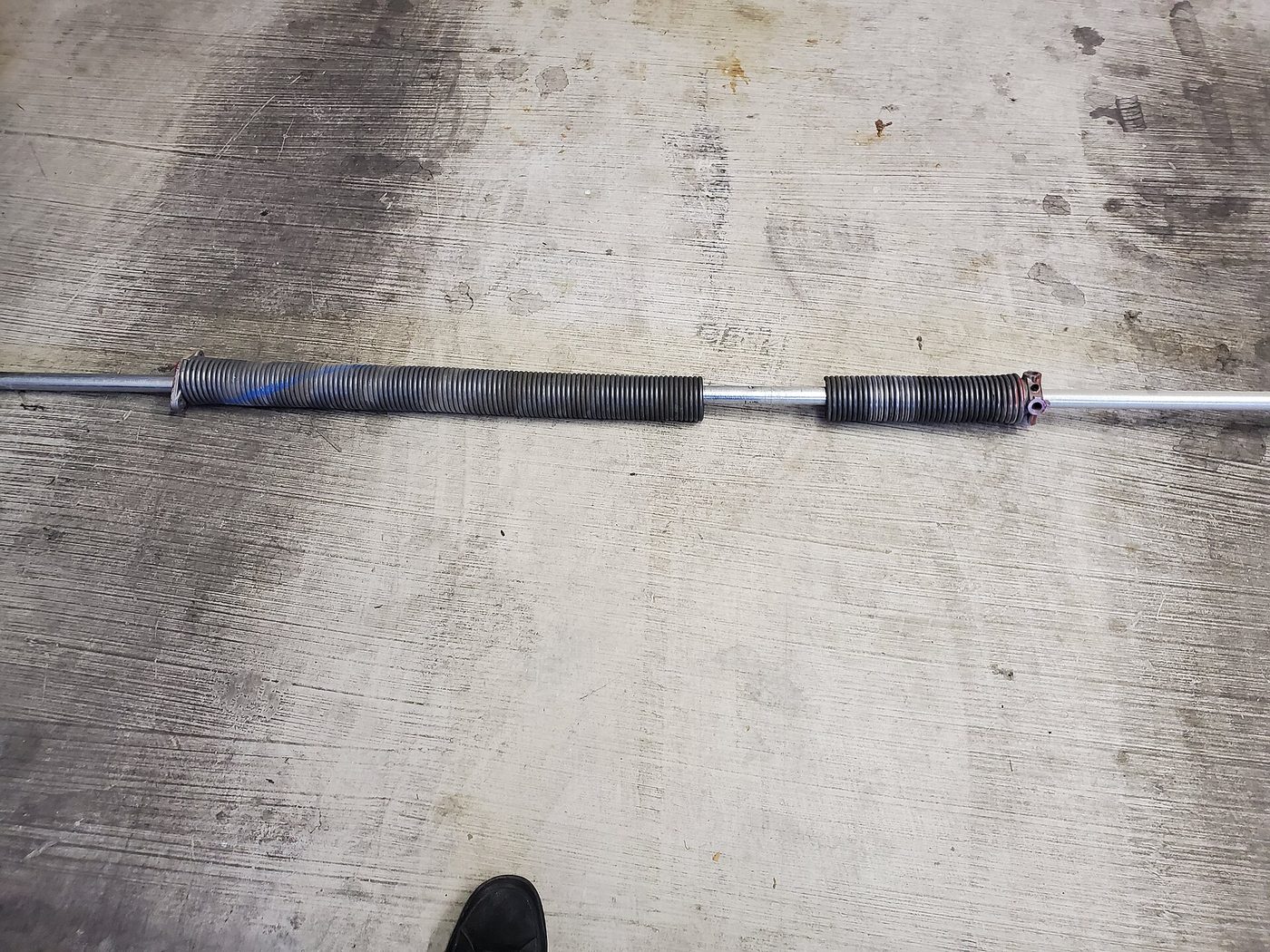 Torsion springs off a garage door shaft after they let go
